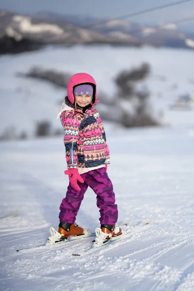 Girl on ski enjoys the ski resort.