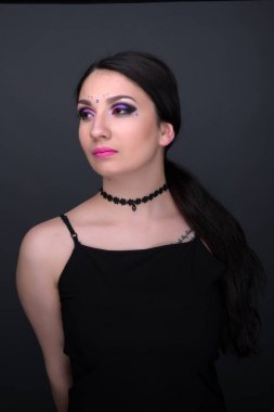 Yüzünü kapat. Gri arka plan üzerinde izole seksi elbiseli genç Arap kadın