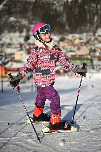 Girl on ski enjoys the ski resort.