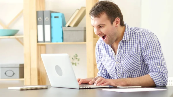 Excited Man Celebrating Success at Work