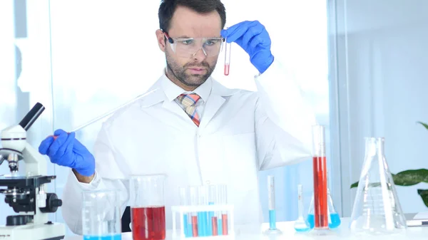 Scientist Busy Doing Chemical Reactions in Laboratory