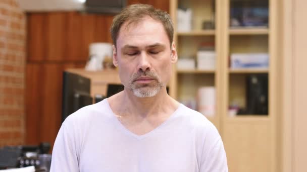Спящий утомленный мужчина среднего возраста на работе, портрет в помещении — стоковое видео