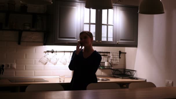 Standing Woman at Night Talking on Phone in Dark Kitchen — Stock Video