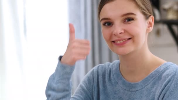 Thumbs Up by Young Woman at Home, Looking at Camera — Stock Video