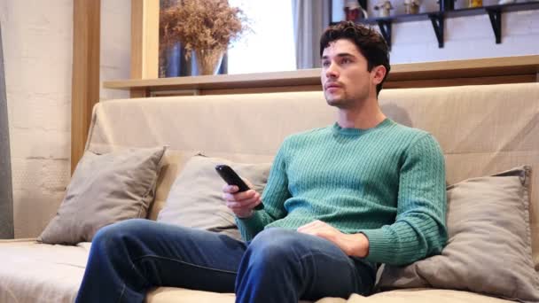 Mann feiert Online-Erfolg, während er Spiel im Fernsehen anschaut — Stockvideo
