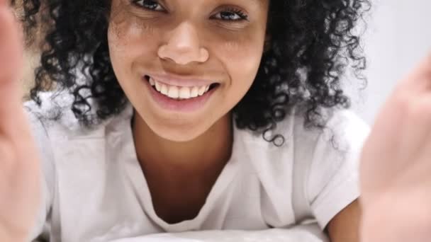 Mulher afro-americana tomando selfie na cama, vista frontal da câmera — Vídeo de Stock