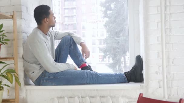 Afro-American Man Sitting at Window and and Looking Outside — Stock Video