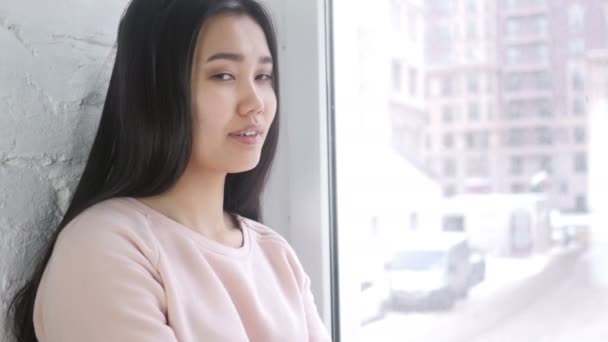 Прекрасная молодая азиатская женщина с победным знаком в помещении — стоковое видео