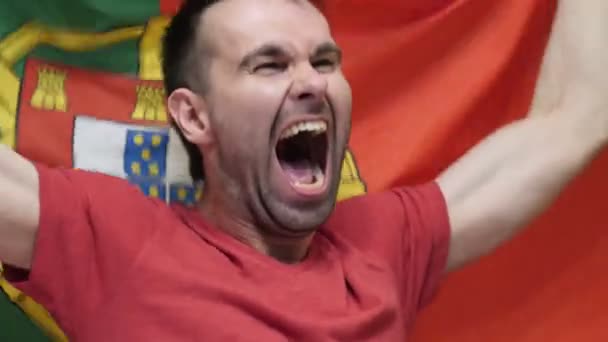Portugalski Fan obchodzi trzymając banderą Portugalii w zwolnionym tempie — Wideo stockowe