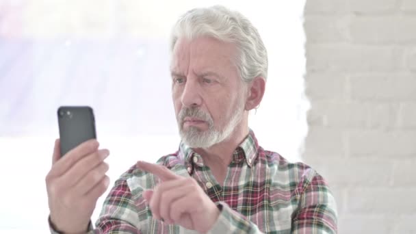 Portrét uvolněného ležérní starý muž pomocí Smartphone — Stock video