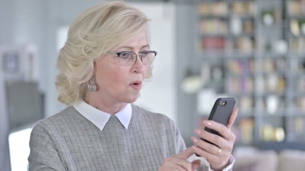 Portrait of Sad Old Woman Reacting to Loss on Smartphone — ストック動画