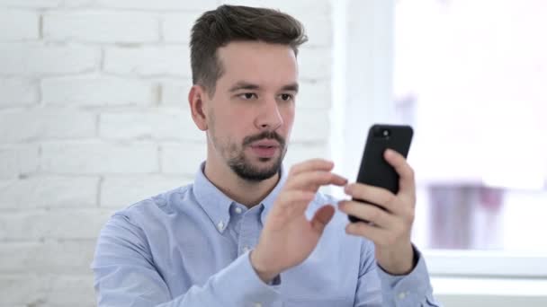 Shoked Creative Man Reacting to Loss on Smartphone — Stock video