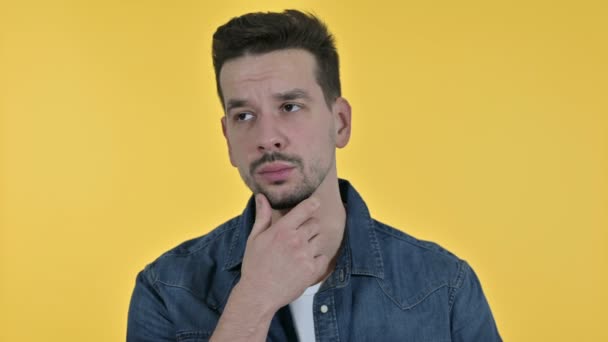 Portrait of Attractive Young Man Thinking and getting Idea, Yellow Background — Stock Video