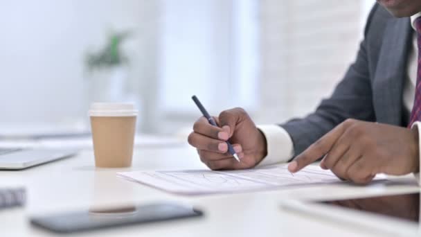 Close up of African Businessman working on Financial Documents in Office — Stok video