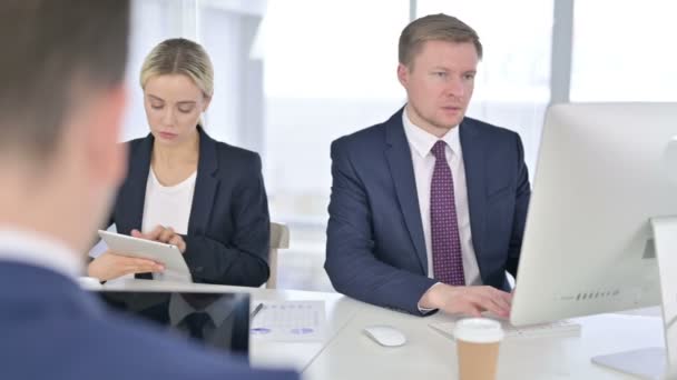 Equipo de negocios enfocado Trabajando en escritorio y tableta en la oficina — Vídeo de stock