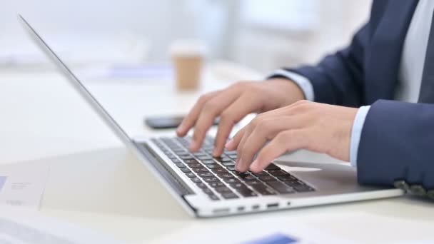 Empresario escribiendo en el ordenador portátil en el trabajo — Vídeos de Stock