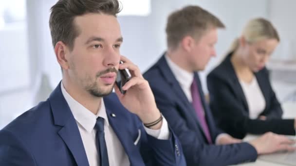 Portrait of Focused Businessman Talking on Smartphone in Office — Stock Video