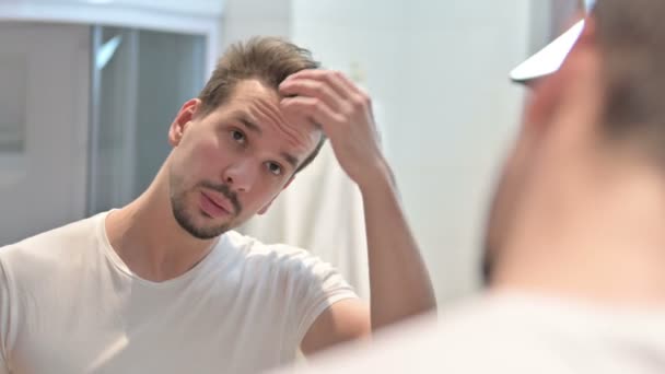 Young Man Fixing Hair in Mirror — Stock Video