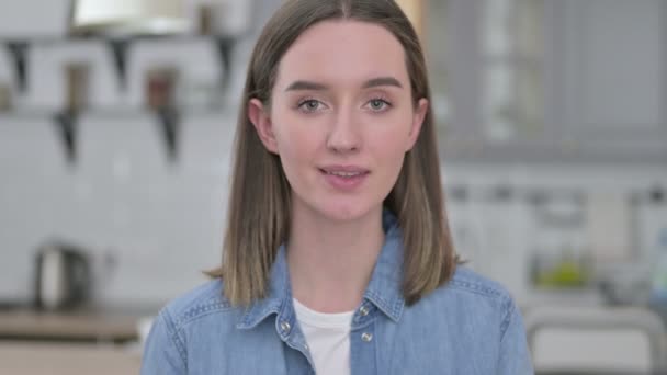 Portret van vrolijke jonge vrouw wijzend en uitnodigend — Stockvideo