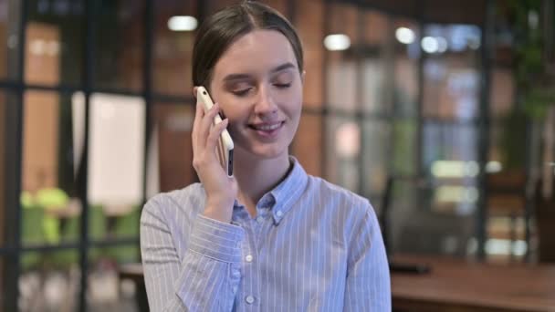 Porträt einer jungen Frau, die am Telefon spricht — Stockvideo