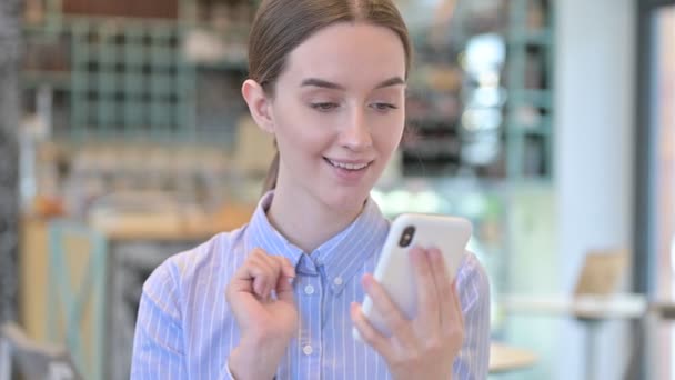 Porträt einer jungen Unternehmerin, die auf dem Smartphone feiert — Stockvideo
