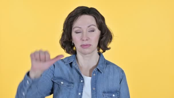 Thumbs Down by Old Woman, Yellow Background — Stock Video