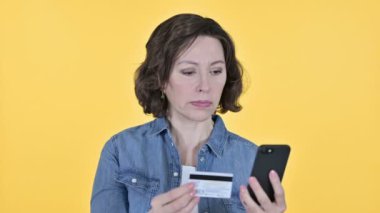 Online Payment on Smartphone by Old Woman, Yellow Background