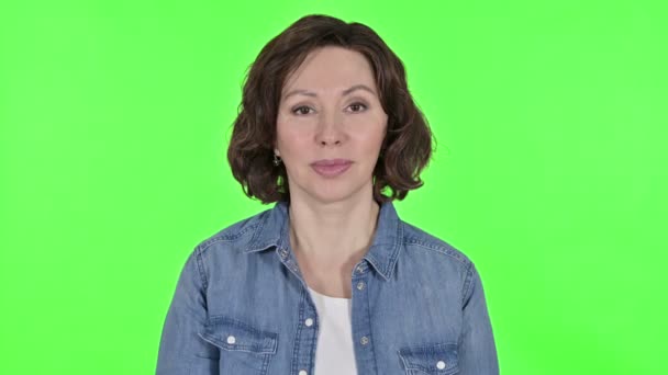 Old Woman Waving at the Camera in Green Chroma Key Background — Stockvideo