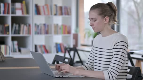 No Finger Sign by Fiatal nő laptoppal a könyvtárban — Stock videók