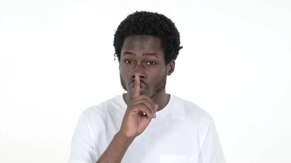 Casual African Man Gesturing Silence, Finger on Lips, vit bakgrund — Stockfoto