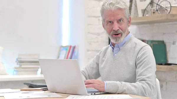 Verbazingwekkende oudere man voelt zich onder de indruk op het werk — Stockfoto