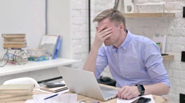İşadamı Dizüstü bilgisayar üzerinde çalışırken yenildiğini hissediyor 
