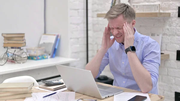 Geschäftsmann spürt Kopfschmerzen bei der Arbeit am Laptop — Stockfoto