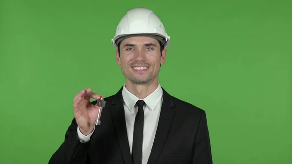 Jovem engenheiro mostrando a chave da casa, Chroma Key — Fotografia de Stock