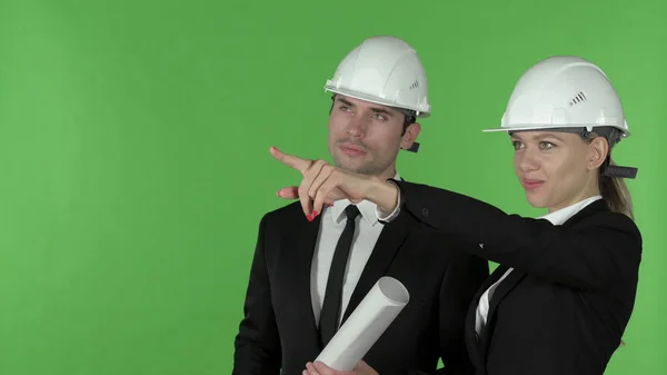 Front View of Female Construction Engineer Pointing up Standing with Male Engineer Holding Blueprint, Chroma Key — Stock Photo, Image