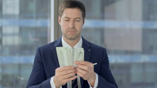 Middle Aged Businessman Counting the Money at Work — Stock Photo, Image