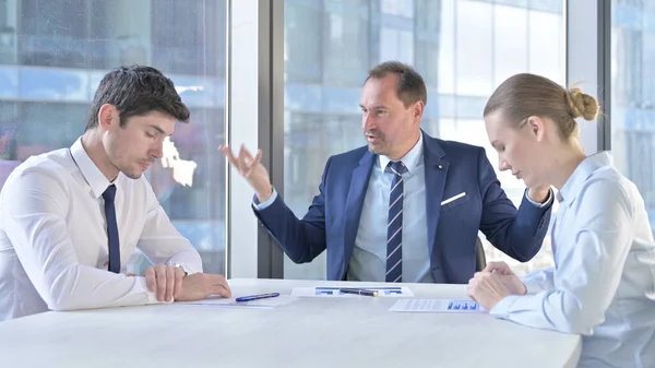 Middle Aged Businessman having getting Angry at Assistants on Office Table — Stock fotografie