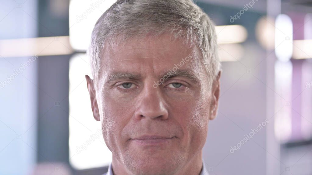Close Up of Serious Middle Aged Man looking at Camera
