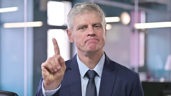 Portrait of Middle Aged Businessman saying No with Finger