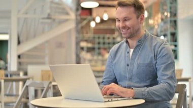 Cafe 'de Sıradan Adam tarafından dizüstü bilgisayarda görüntülü sohbet 