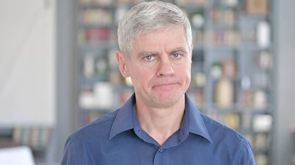 Portrait of Handsome Middle Aged Man saying No by Shaking Head