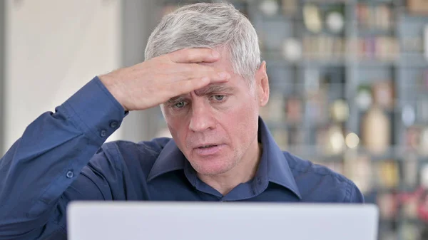 Retrato del hombre con dolor de cabeza mientras trabaja en el ordenador portátil —  Fotos de Stock