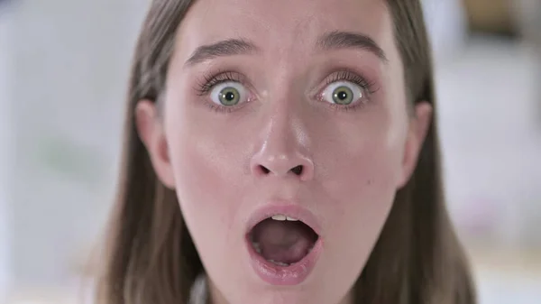 Close-up van jonge vrouw krijgen shock in camera — Stockfoto