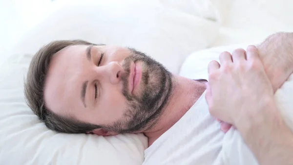 Hombre joven barba preocupado tratando de dormir en la cama —  Fotos de Stock