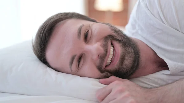 Close Up of Cheerful Beard Young Man Smiling at Camera in Bed — Stock Photo, Image