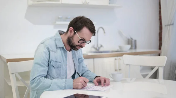 Beard Young Man Thinking and Writing on Paper — Stock Photo, Image