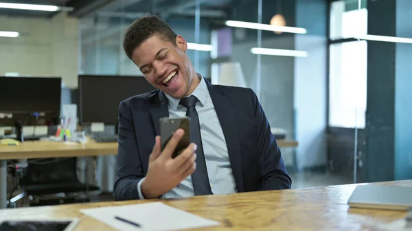 Jovem empresário africano recebendo surpresa no smartphone — Fotografia de Stock