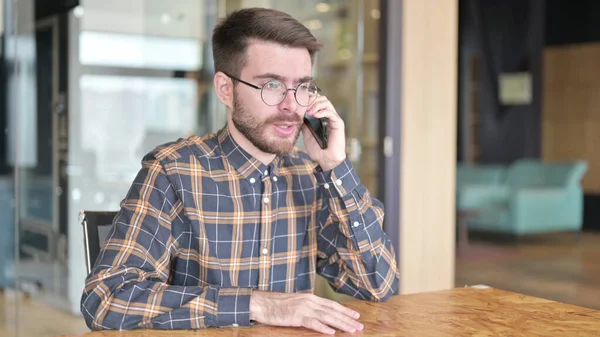 Jovem Designer atraente falando no Smartphone no escritório — Fotografia de Stock