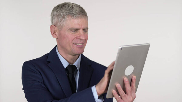 Senior Businessman Browsing Internet on Tablet, White Background