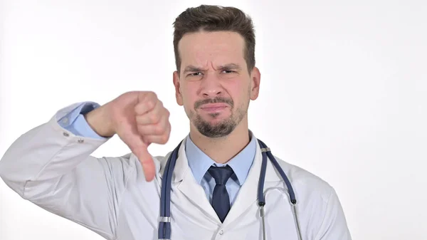 Jovem Médico masculino mostrando polegares para baixo, fundo branco — Fotografia de Stock